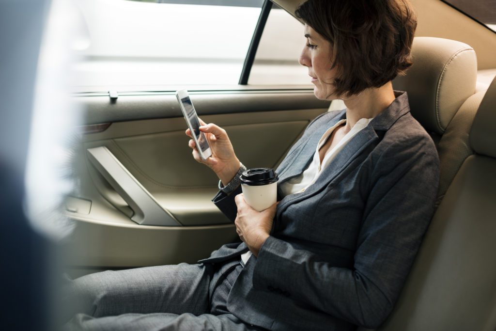 Businesswoman,Using,Smart,Phone,Car,Inside Pretty Women Having Party In A Limousine Car